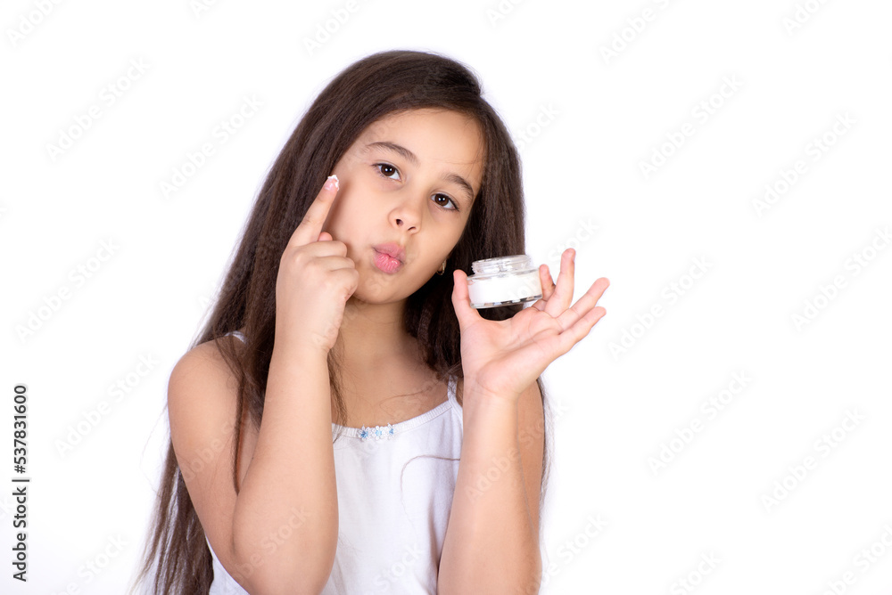 Happy child presenting beauty cosmetic product of facial skin cream Happy child presenting beauty cosmetic product of facial skin cream