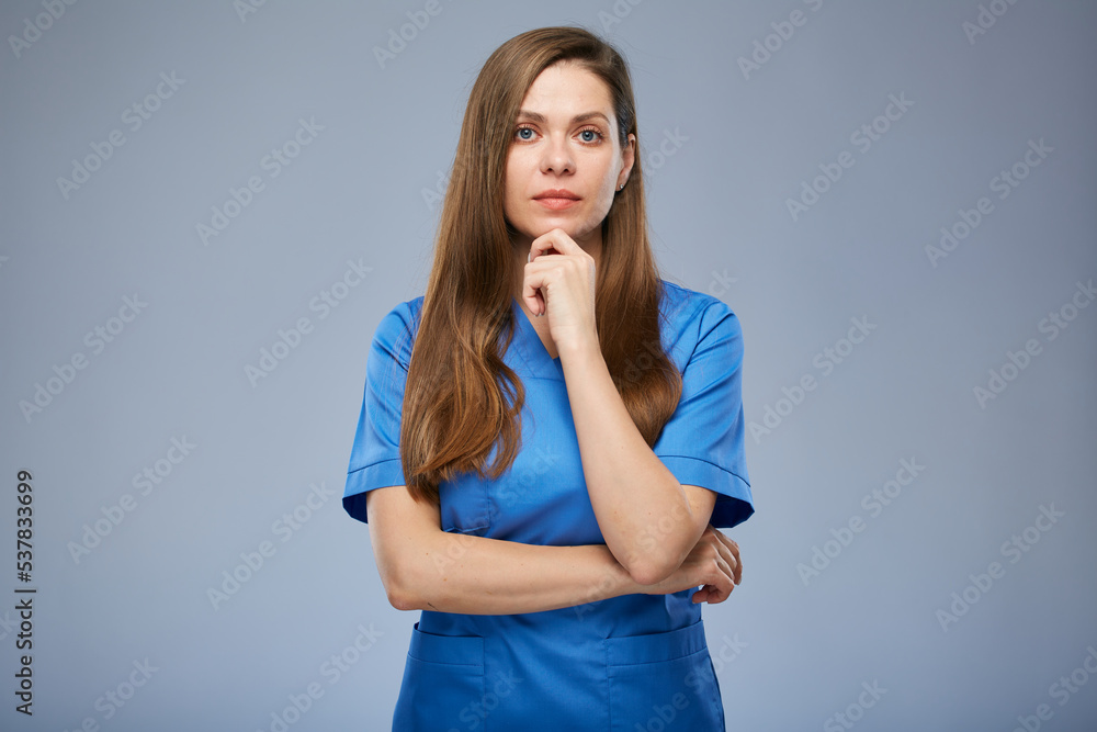 Serious thinking nurse woman in blue medical uniform. Isolated female portrait. Serious thinking nurse woman in blue medical uniform. Isolated female portrait.