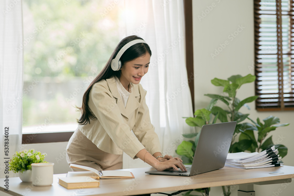 Asian woman working with customers in office Asian woman working with customers in office