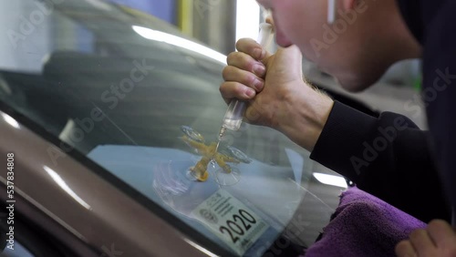 Application of a special polymer through a syringe. Repair cracks and chips on windshields