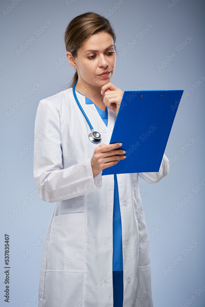 Doctor reading medical history on clipboard. isolated female portrait. Doctor reading medical history on clipboard. isolated female portrait.