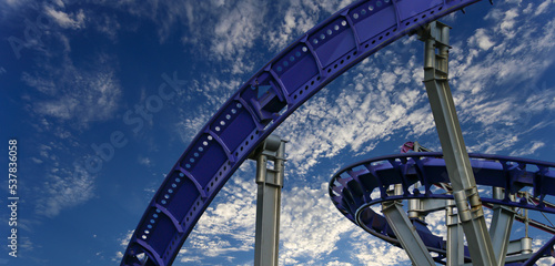 Fototapeta Naklejka Na Ścianę i Meble -  Attraction roller-coaster (switchback) on the background of the cloudy sky
