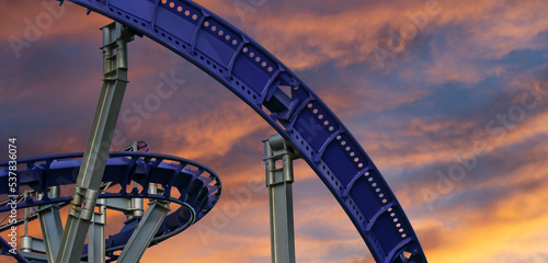 Fototapeta Naklejka Na Ścianę i Meble -  Attraction roller-coaster (switchback) against the background of a romantic evening sky