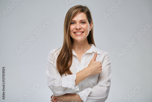 Portrait of smiling woman showing thumb up. Girl with big wide smile.