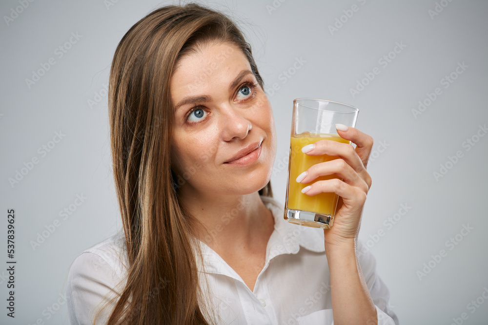 Close up face of smiling woman. Girl holding orange juice glass. Isolated female advertising portrait. Close up face of smiling woman. Girl holding orange juice glass. Isolated female advertising portrait.