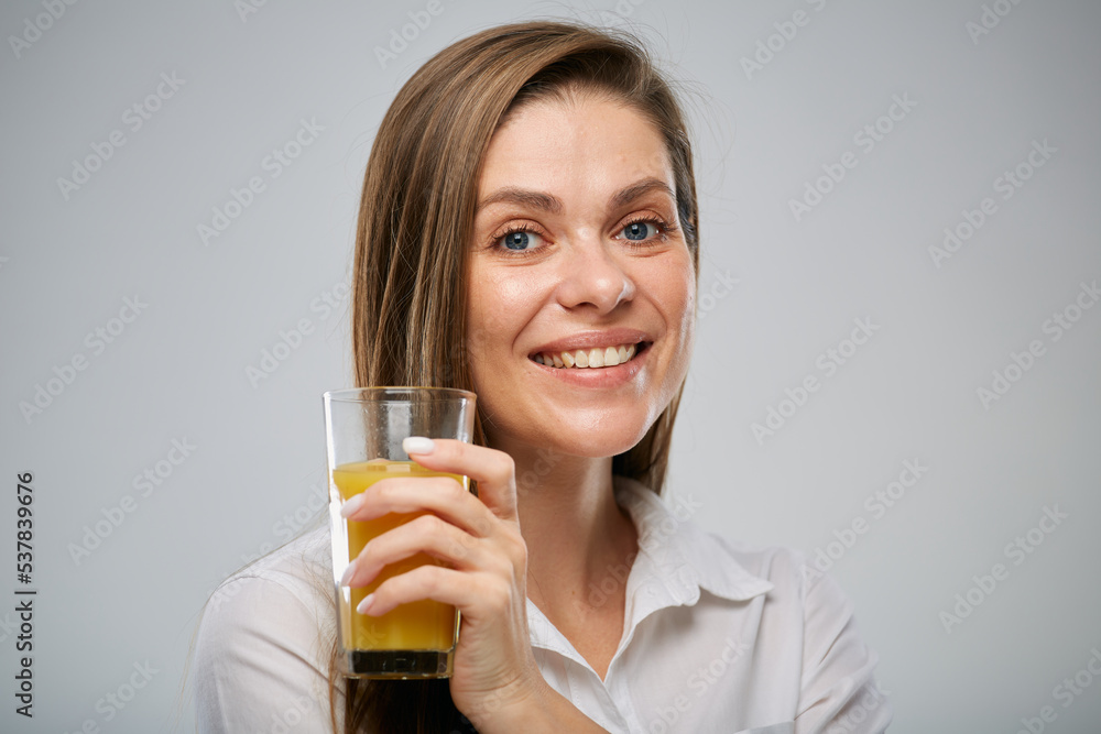 Smiling woman holding orange juice glass. Isolated female advertising portrait. Smiling woman holding orange juice glass. Isolated female advertising portrait.