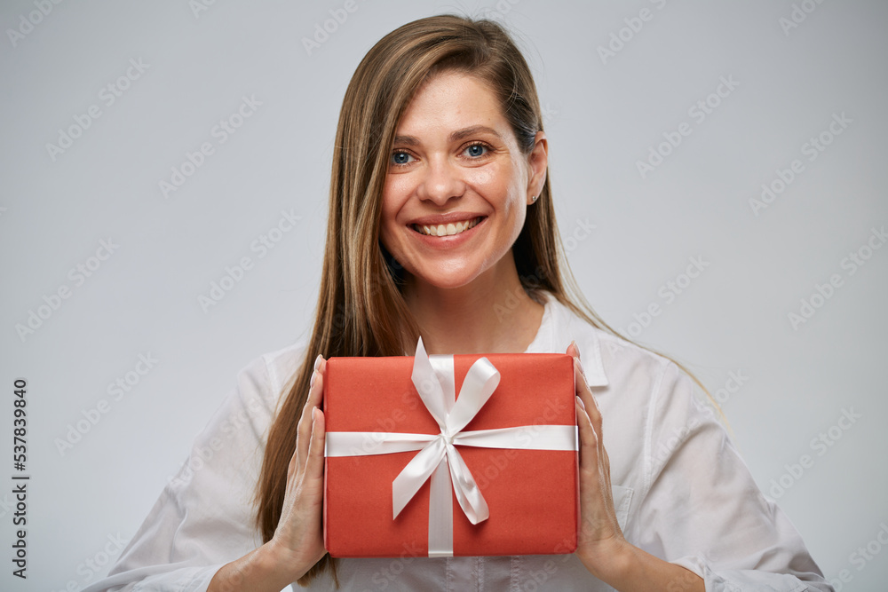 Happy woman holding gift box. Isolated female portrait. Happy woman holding gift box. Isolated female portrait.