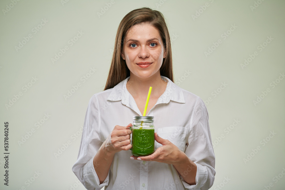 Smiling woman holding glass with green smoothie. Isolated female advertising portrait. Smiling woman holding glass with green smoothie. Isolated female advertising portrait.