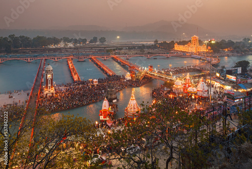 HARIDWAR, UTTARAKHAND, INDIA:crowd of Indian pilgrims gathering for prayers by the Yamuna River, Har-Ke-Pauri Ghat, Khumb Mela festival, Makar Sankranti celebration photo