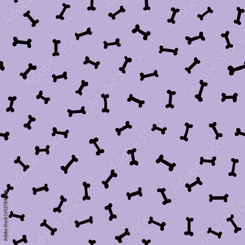 Small black bones scattered on a pastel purple background cute Halloween seamless pattern. Doggy bone light violet repeat background.