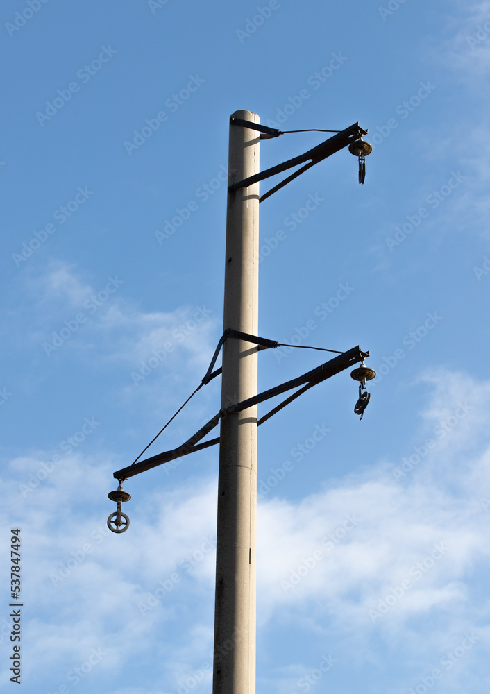 Concrete electric pole without wires against the sky.