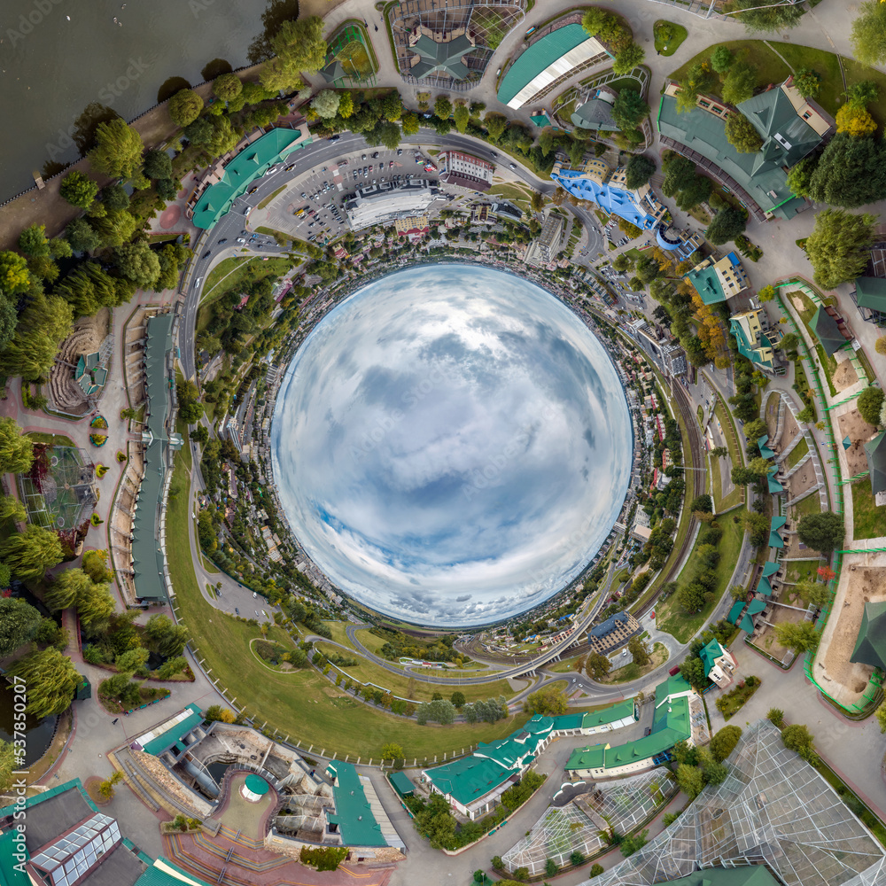 blue sphere inside overlooking old town, urban development, historic buildings and crossroads with cars. Transformation of spherical 360 panorama in abstract aerial view.