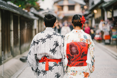 Young Man and Young women wearing traditional Japanese Kimono with colorful maple trees in autumn is famous in autumn color leaves and cherry blossom in spring, Kyoto, Japan.