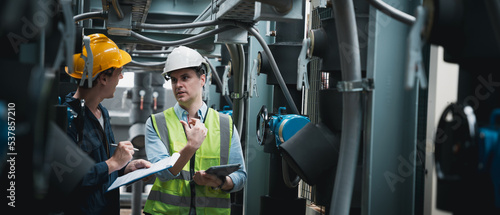 Fotografie Engineer and team examining the air conditioning cooling system of a huge building or industrial site