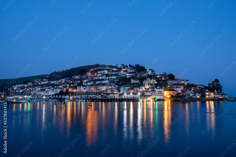 The Kingswear side of Dartmouth Harbour illuminated at dusk on a winters afternoon.