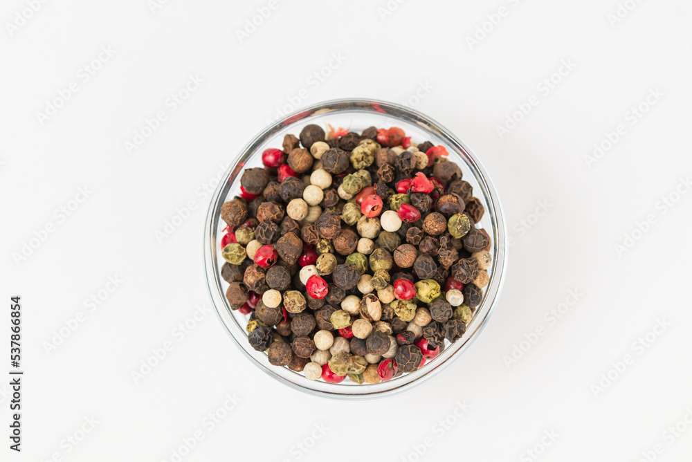 Top view of a mixture of peppers in glass bowl isolated on white background Top view of a mixture of peppers in glass bowl isolated on white background