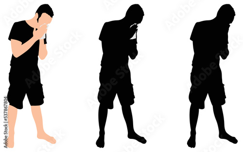 Young man blowing nose into a tissue