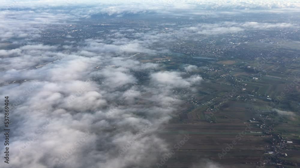 View from the airplane window. Airplane wing with landscapes of forests, trees, clouds, sky, city, fields and nature. View from above airplane landscape. Nature landscape from flying plane. View from the airplane window. Airplane wing with landscapes of forests, trees, clouds, sky, city, fields and nature. View from above airplane landscape. Nature landscape from flying plane.