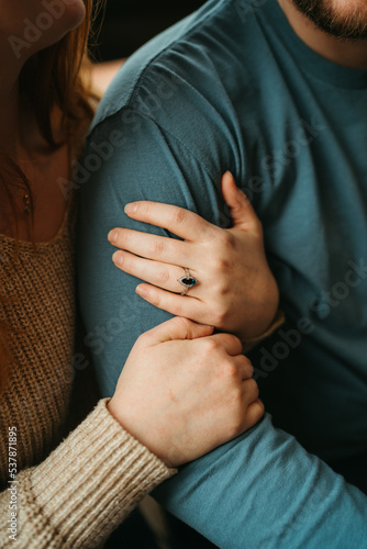 Engaged couple holding hands 