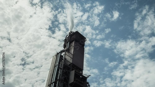 Stary Oskol, Russia - May 21, 2021: Factory building and clouds photo