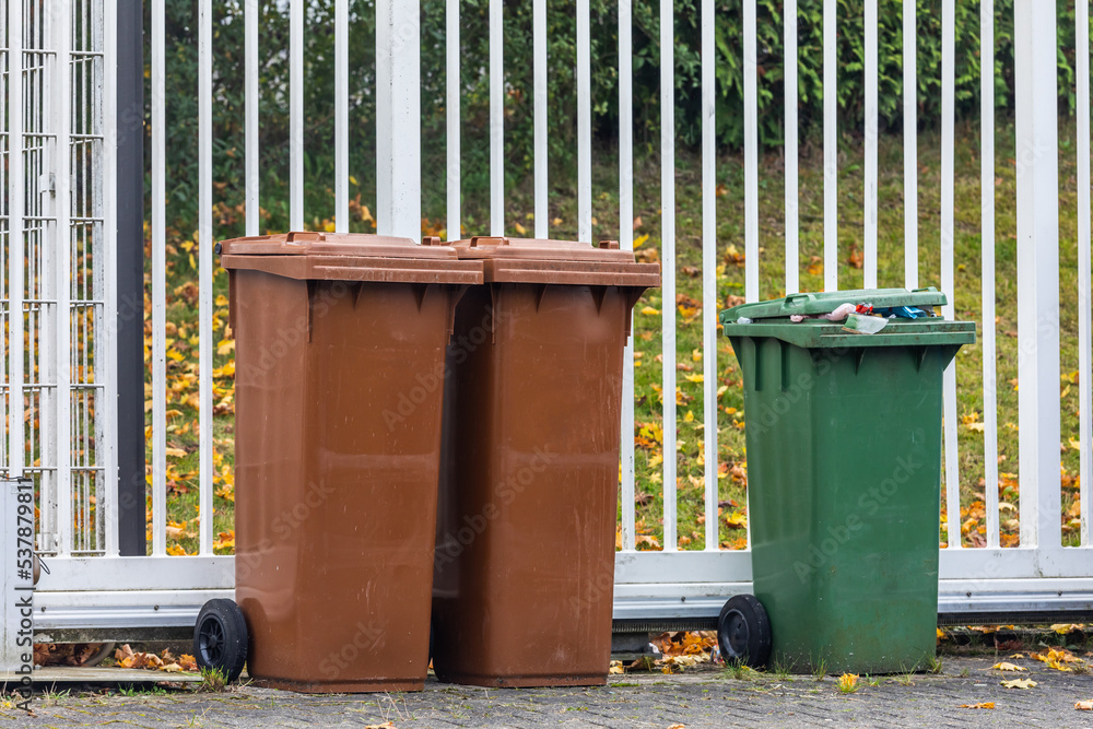 Fototapeta premium garbage sorting. colorful trash cans in the backyard.waste recycling