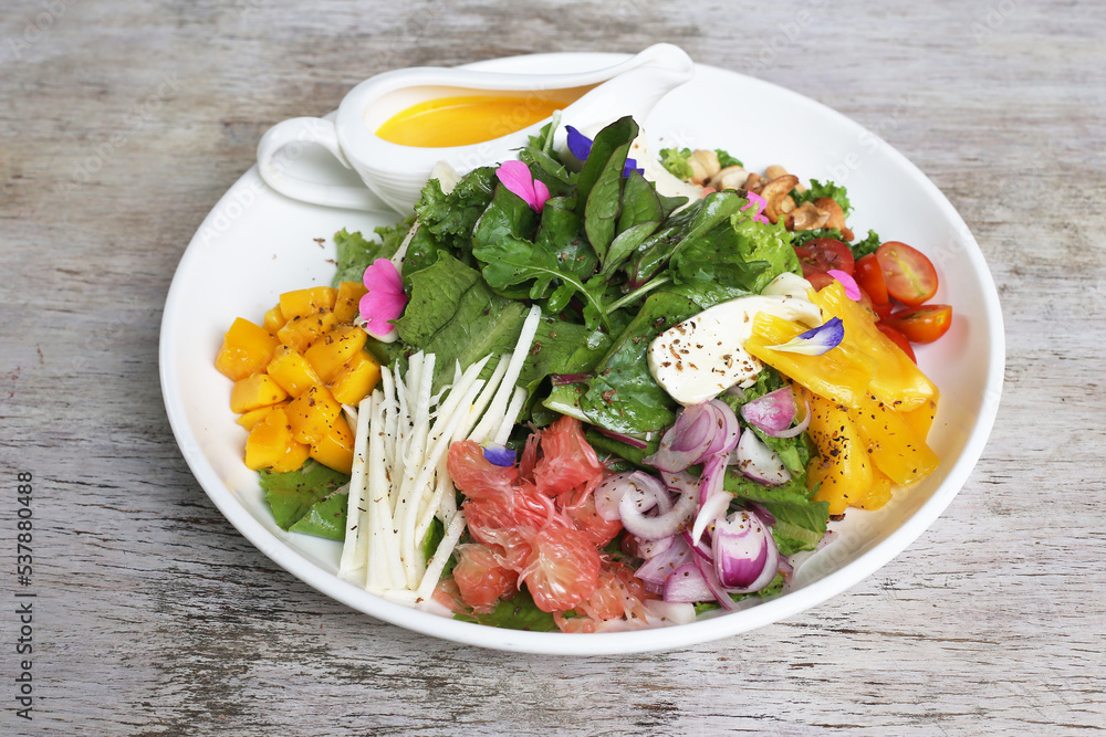 The local salad served in a dish isolated on grey background side view of salad The local salad served in a dish isolated on grey background side view of salad
