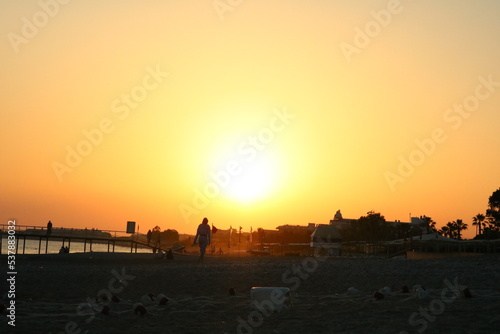 a beautiful, bright sunset on the beach © Yaraslava