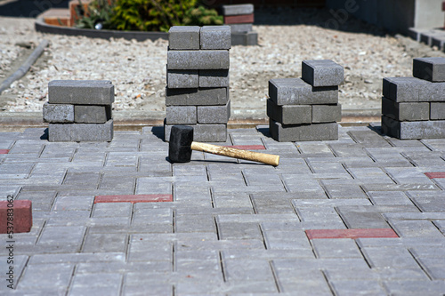 Paving slabs of different colors and shapes.Texture of different colored patterned paving slabs . Modern road surface.