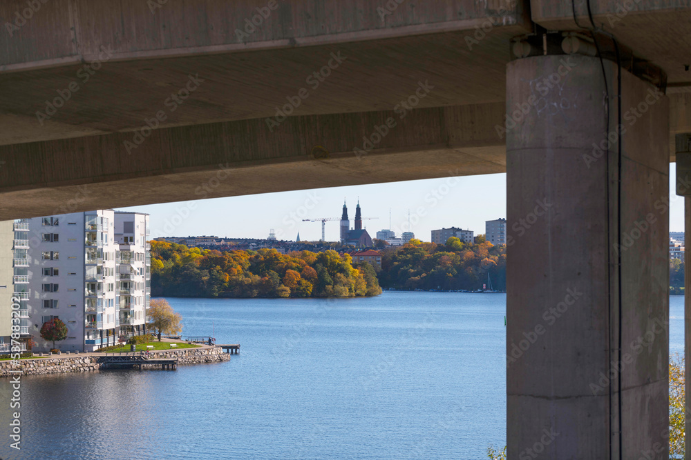 View from under the motorway Essingeleden, Lux district on the island Lilla Essingen, district Södermalm at a bay in the lake Mälaren a sunny a color full autumn day in Stockholm