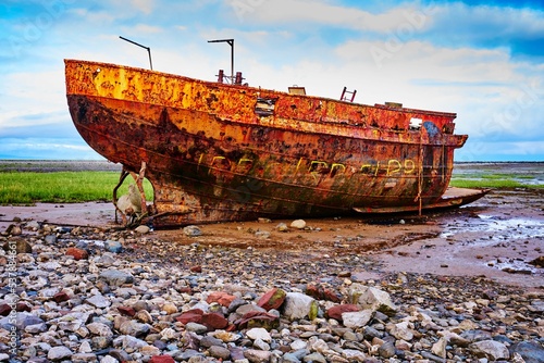 Rusty shipwreck in the mud of the Walney Channel in Roa Island, Cumbria, England, UK photo