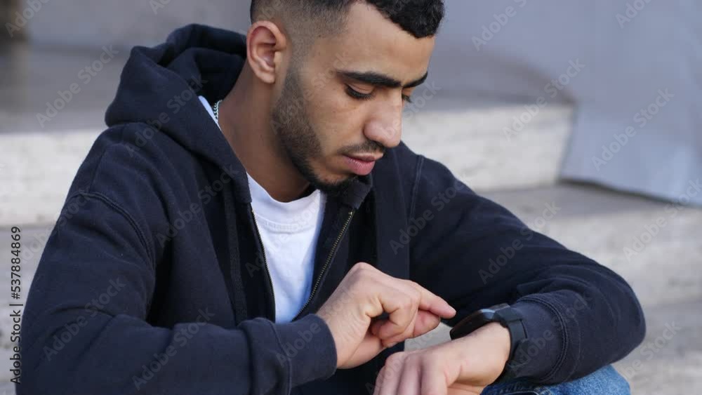 Tunisian male hand touching screen generic design smart watch Tunisian male hand touching screen generic design smart watch