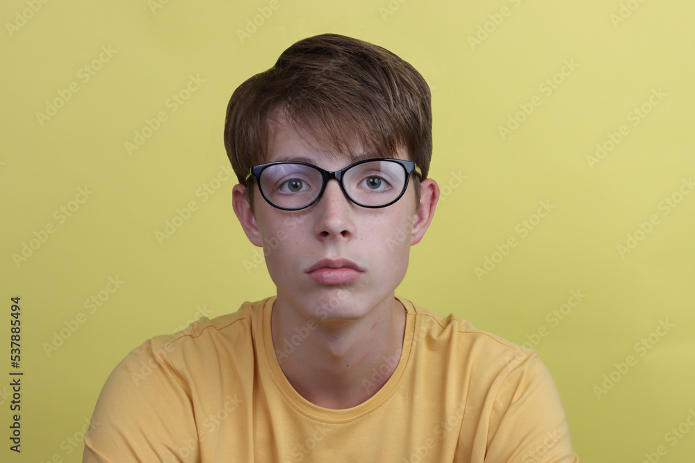 Portrait of a cute teen boy with glasses.