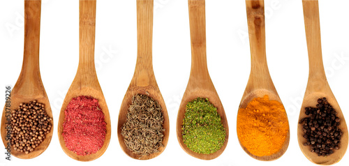 Various colorful spices in spoons on white table