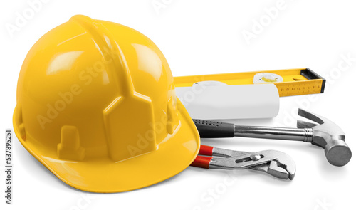 Yellow hard hat and tools on background photo