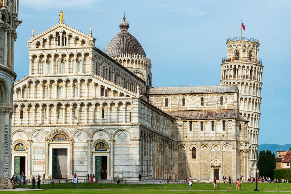 Tourists visiting Pisa´s cathedral and leaning tower in miracles square