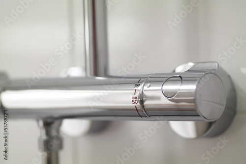 Shower faucet with thermostatic control. Selective focus.