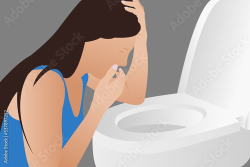 A young woman throws up over the toilet at an early stage of pregnancy, or after drinking
