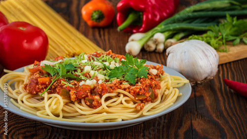 Italian spaghetti with ingredients on a wooden table