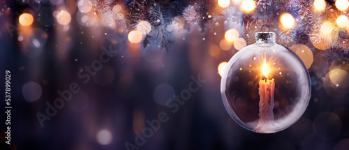 Christmas Hope - Advent Candle With Bright Flame In Ball Hanging Tree With Defocused Background - Prayer Concept photo