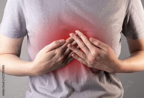Fotografie Chest pain. Hands on solar celiac plexus. Breast aching