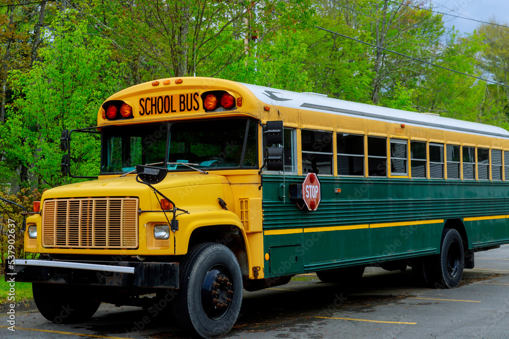 Traditional school bus on road transports children to school every day as part their daily routine. Traditional school bus on road transports children to school every day as part their daily routine.