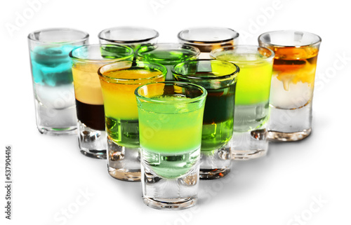 Colourful shot drinks on a white background with reflections photo