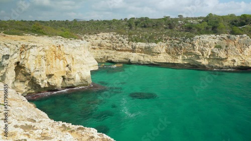 Wallpaper Mural Rocky bay with clear green water as seen from above cliff, camera panning to side Torontodigital.ca