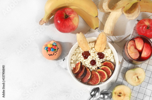 Healthy breakfast with ingredients, fun food for kids. Cottage cheese with figs and bananas, apples and grapes, top view, Healthy and natural food concept.