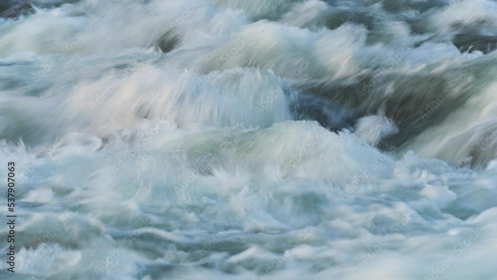 Abstract timelapse video - long exposure shots of water flowing in river over rocks Abstract timelapse video - long exposure shots of water flowing in river over rocks