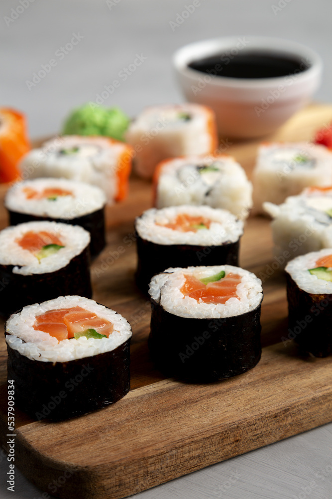 Homemade Sushi Platter with Wasabi and Soy Sauce on a Board, side view. Homemade Sushi Platter with Wasabi and Soy Sauce on a Board, side view.