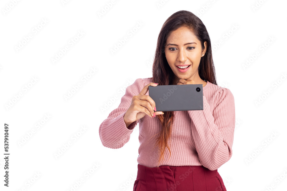 Cheerful young woman watching video in mobile phone isolated on white. Cheerful young woman watching video in mobile phone isolated on white.