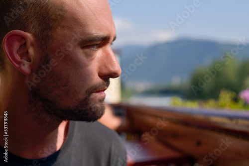 Man looking at Italian panorama sitting at restaurant photo
