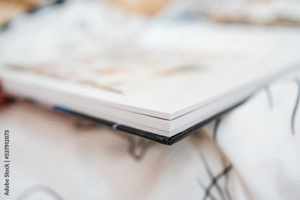 Selective focus and blurry photos. a woman holds a photo book. Selective focus and blurry photos. a woman holds a photo book.