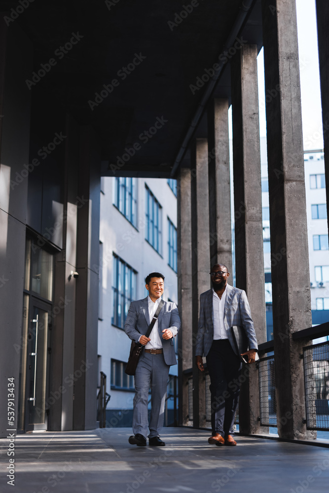 Man walking with colleague at office space Man walking with colleague at office space